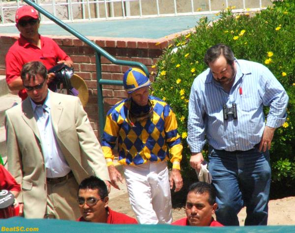 …and here’s Baze with an Owner, probably asking why his horse jumped in the air as he was coming out of the gate, and then finished dead last (Hey — just like Big Brown).